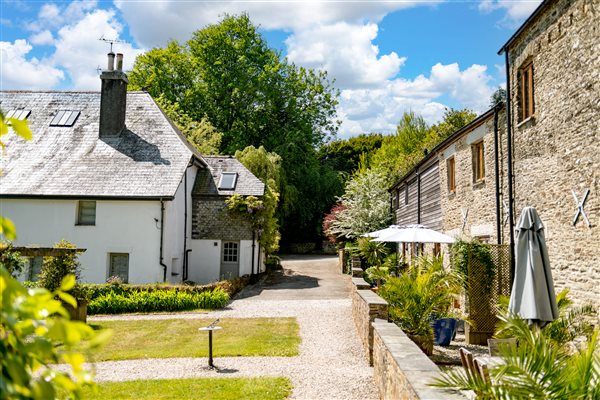 View of cottages and farmhouse with terrace seating